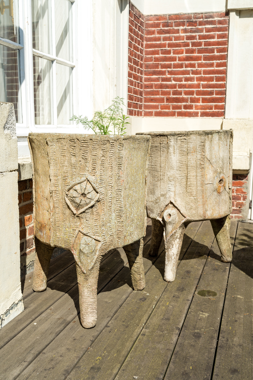 A pair of faux-bois tripod planters, 20th C.