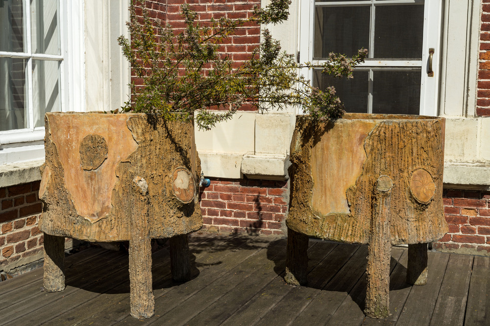 A pair of faux-bois tripod planters, 20th C.