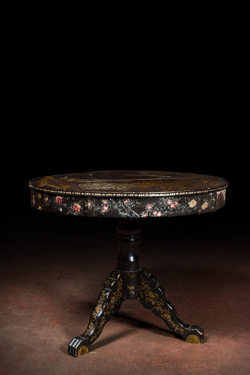 A black lacquered table with polychrome chinoiserie design and mother-of-pearl inlay, ca. 1900