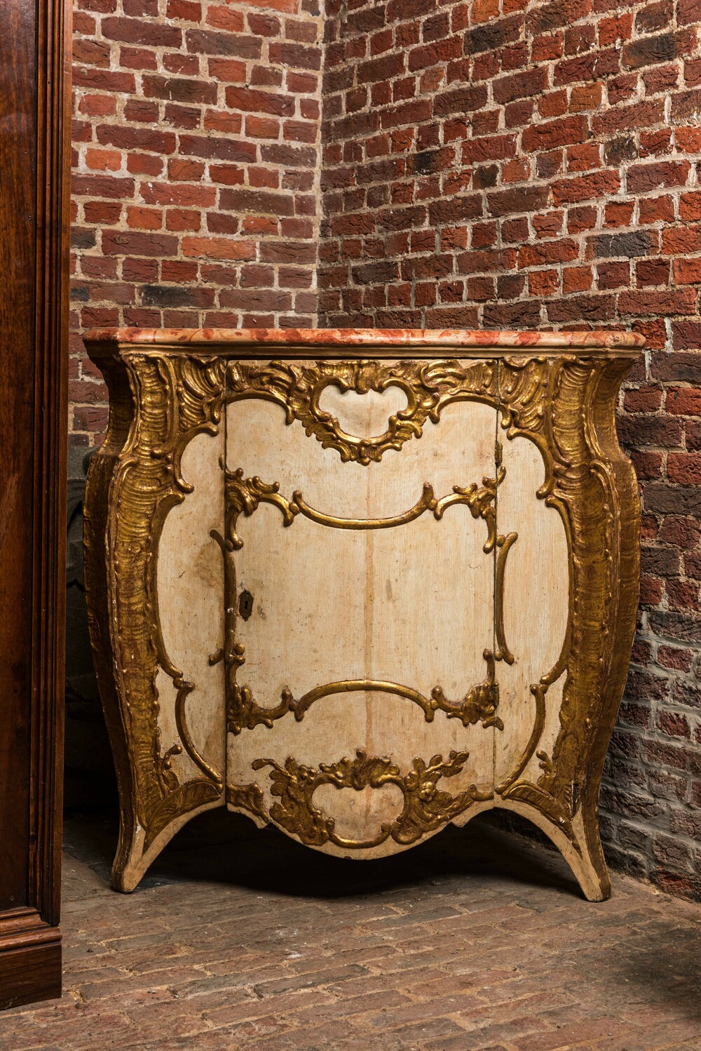 A patinated and gilt Louis XV corner cupboard with faux marble top, 18th C.