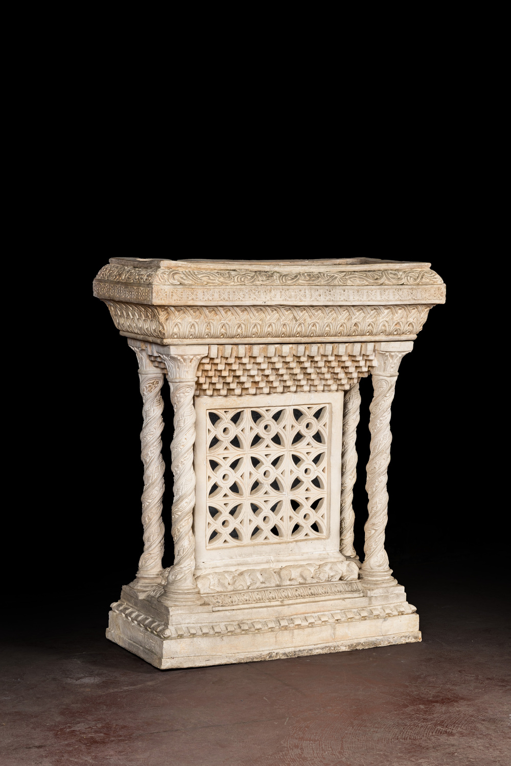 A large white patinated plaster jardini&egrave;re in Romanesque-style, 20th C.