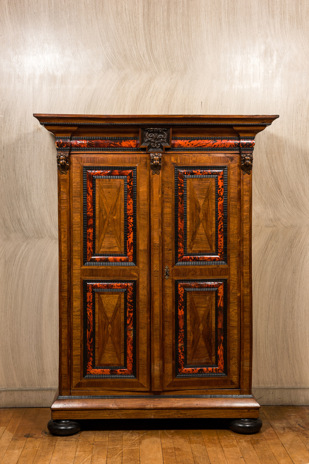 A Flemish wooden two-door cupboard with tortoiseshell and ebonised accents, 17th C. and later