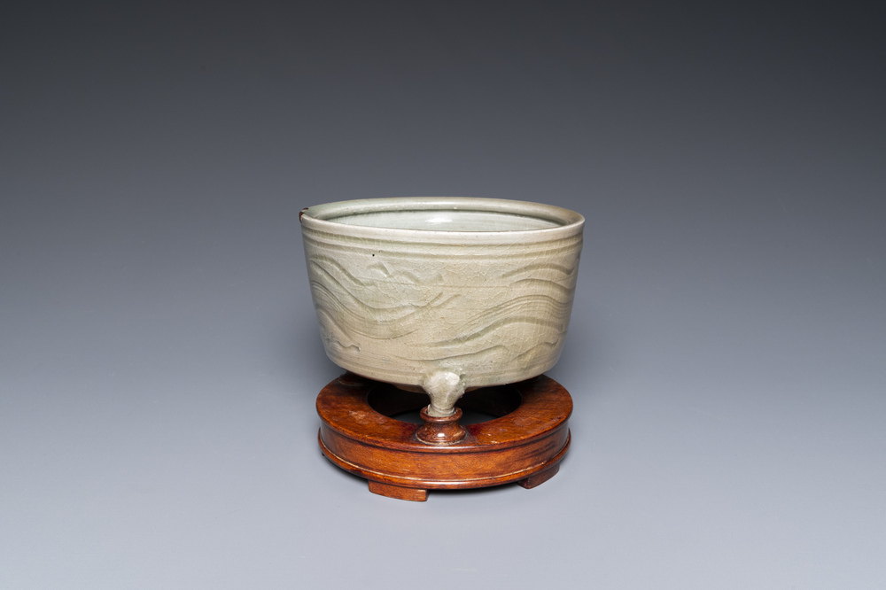 A Chinese Longquan tripod censer with kintsugi repair on wooden stand, Ming