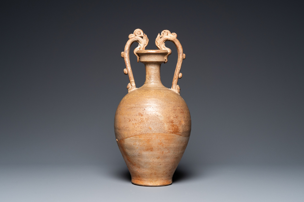 A Chinese straw-glazed stoneware amphora with dragon handles, Tang