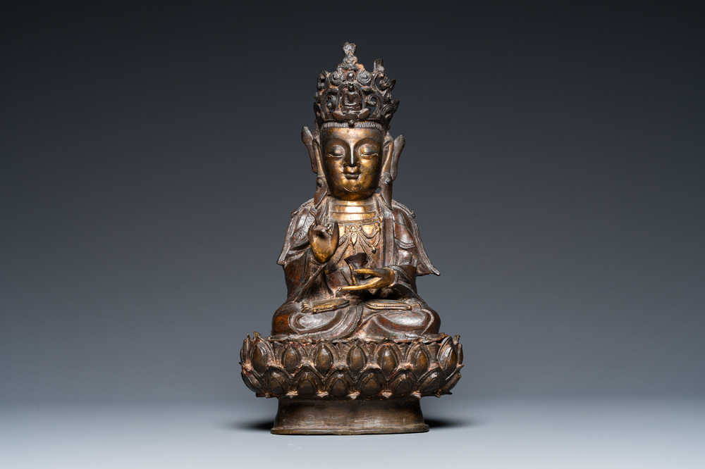 A Chinese partly gilt bronze figure of Guanyin on a lotus throne, Ming