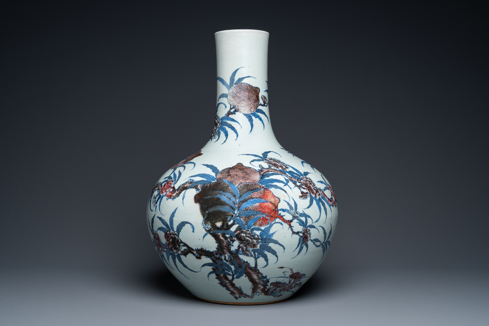 A Chinese blue, white and copper-red 'nine peaches' bottle vase, Guangxu mark and of the period