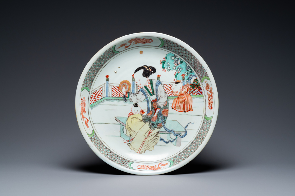 A Chinese famille verte dish with a lady and two playing boys, Kangxi