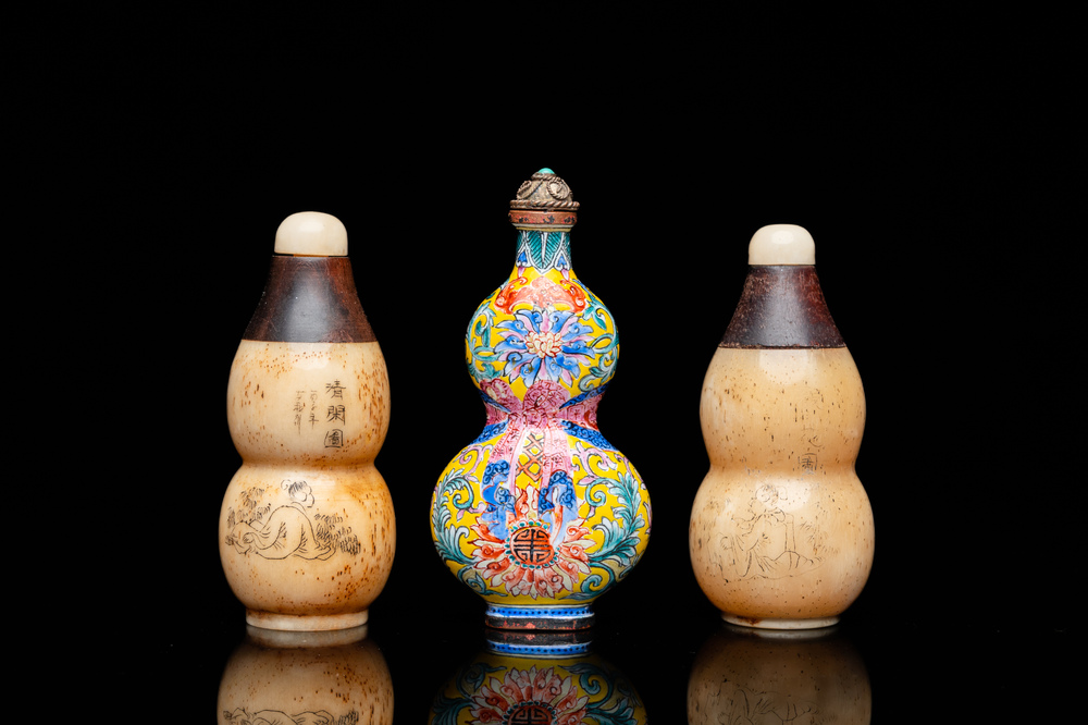 A Chinese Canton enamel snuff bottle and a pair of bone snuff bottles, 19th C.