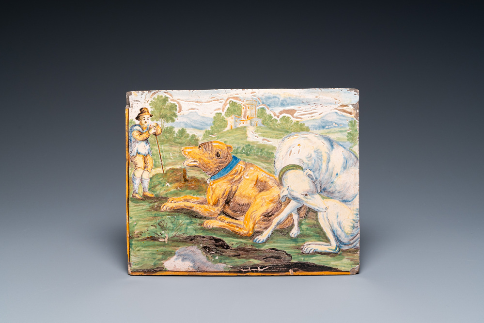 A polychrome faience plaque with a shepherd with two large dogs, Castelli, Italy, 18th C.