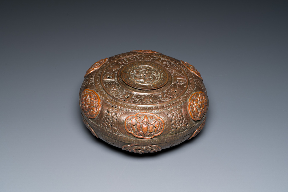 A Tibetan pierced and repouss&eacute; copper scent box and cover with inscribed mantra, 18/19th C.