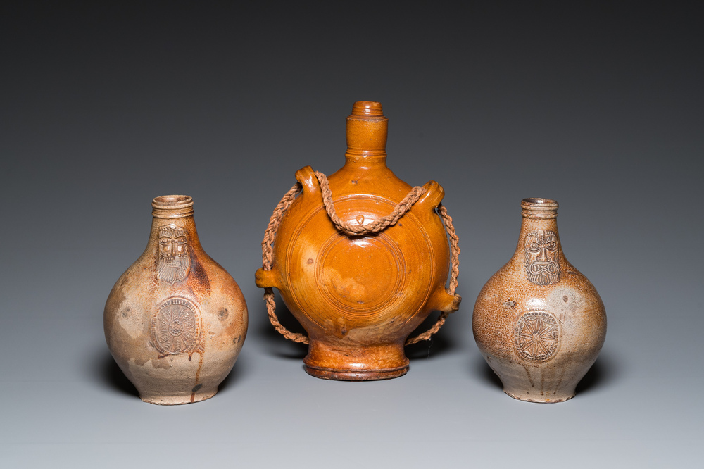 Two German stoneware bellarmine jugs and a pilgrim's flask, 17th C.