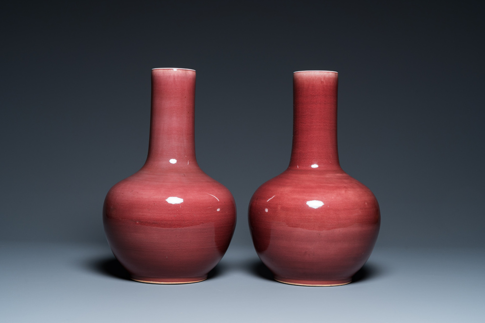 A pair of Chinese monochrome peachbloom-glazed bottle vases, 19th C.