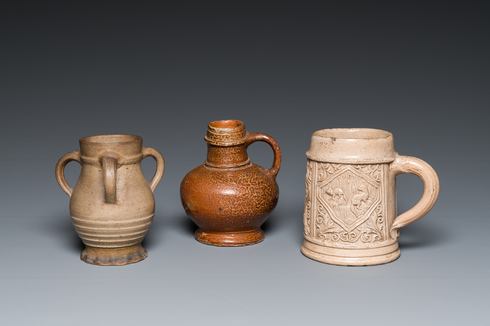 A German stoneware mug and two jugs, Raeren and Cologne, 16/17th C.