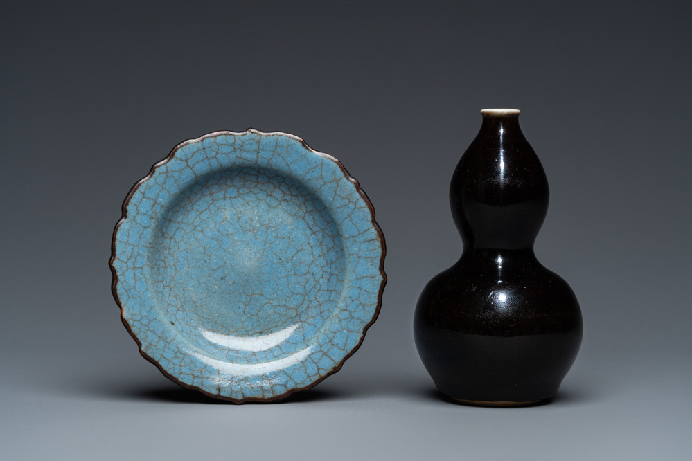 A small Chinese black-glazed double gourd vase and a blue crackle-glazed saucer dish, Qing