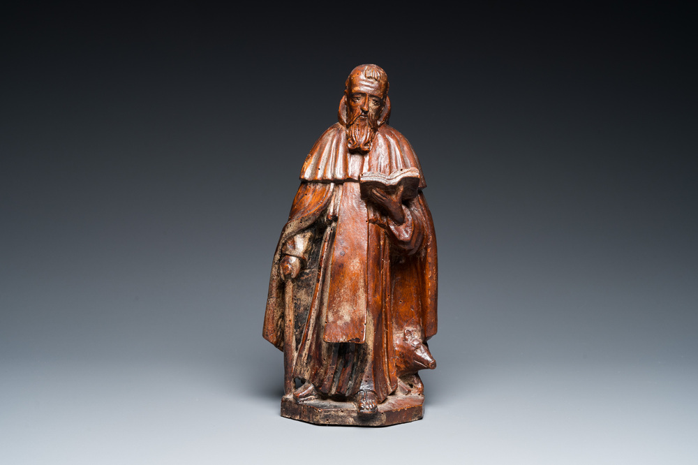 A carved oak group of the reading Saint Anthony with a pig, 17th C.