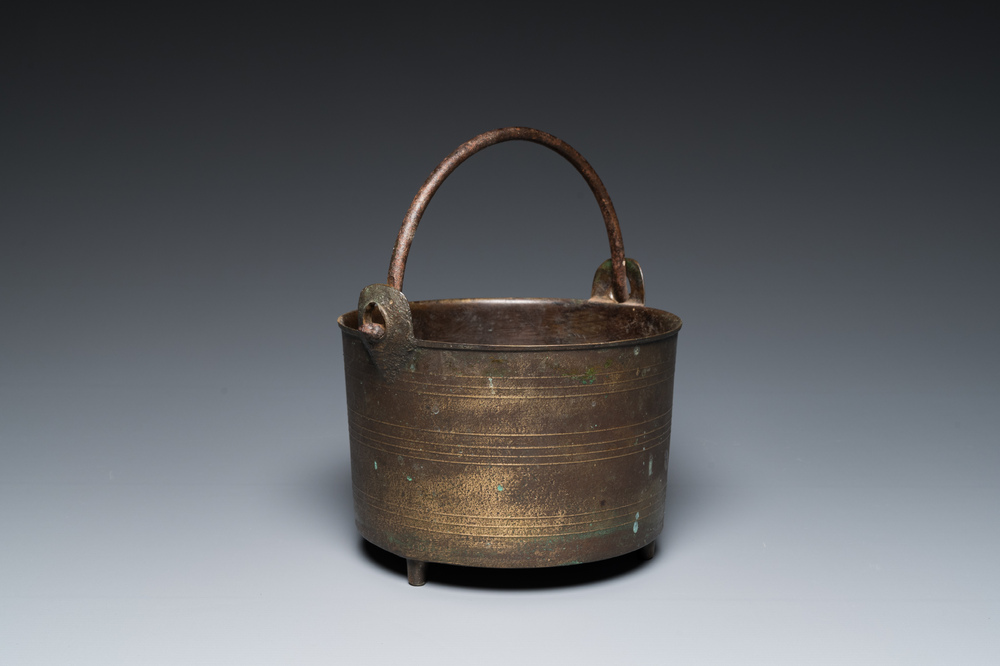 A bronze tripod kettle with handle, probably France, 17th C.