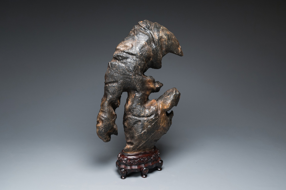 An exceptionally large Chinese 'gongshi' or 'scholar's rock' on wooden stand, probably Qing