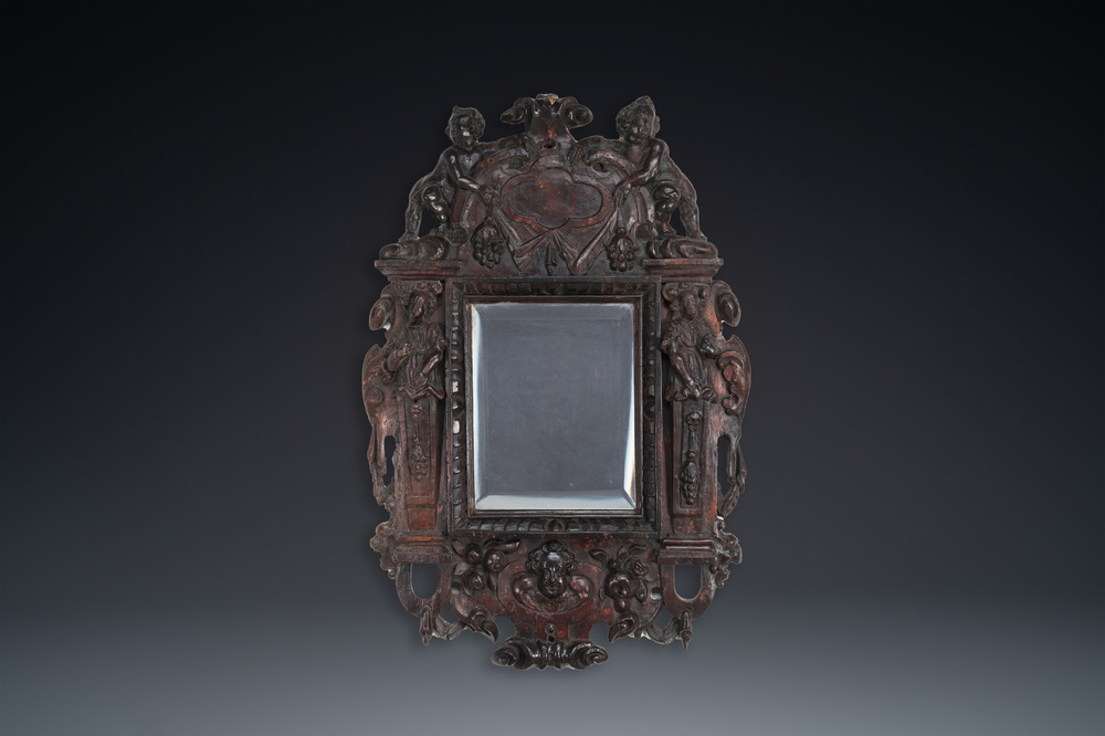 A carved oak mirror with cherubs and caryatids, the Low Countries, 17th C.