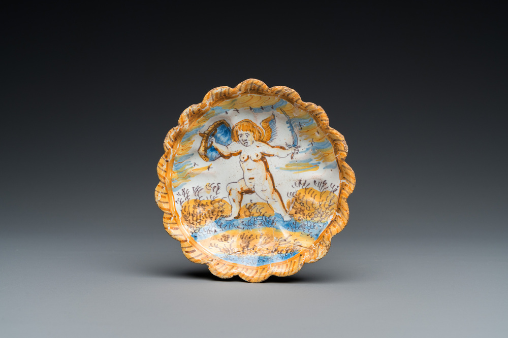 A small polychrome maiolica dish with a fighting putto, Verstraeten workshop, Haarlem, 17th C.