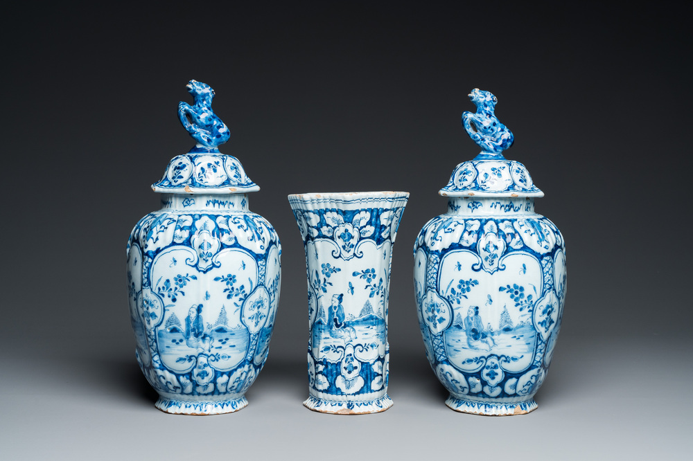 A Dutch Delft blue and white chinoiserie garniture of three vases, 18th C.