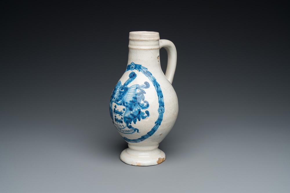 A Portuguese blue and white armorial ewer inscribed Jacob Schr&ouml;der, Lisbon, dated 1644