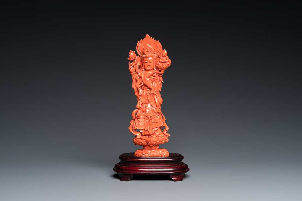A Chinese red coral carving of Guanyin standing on a lotus throne, 19th C.