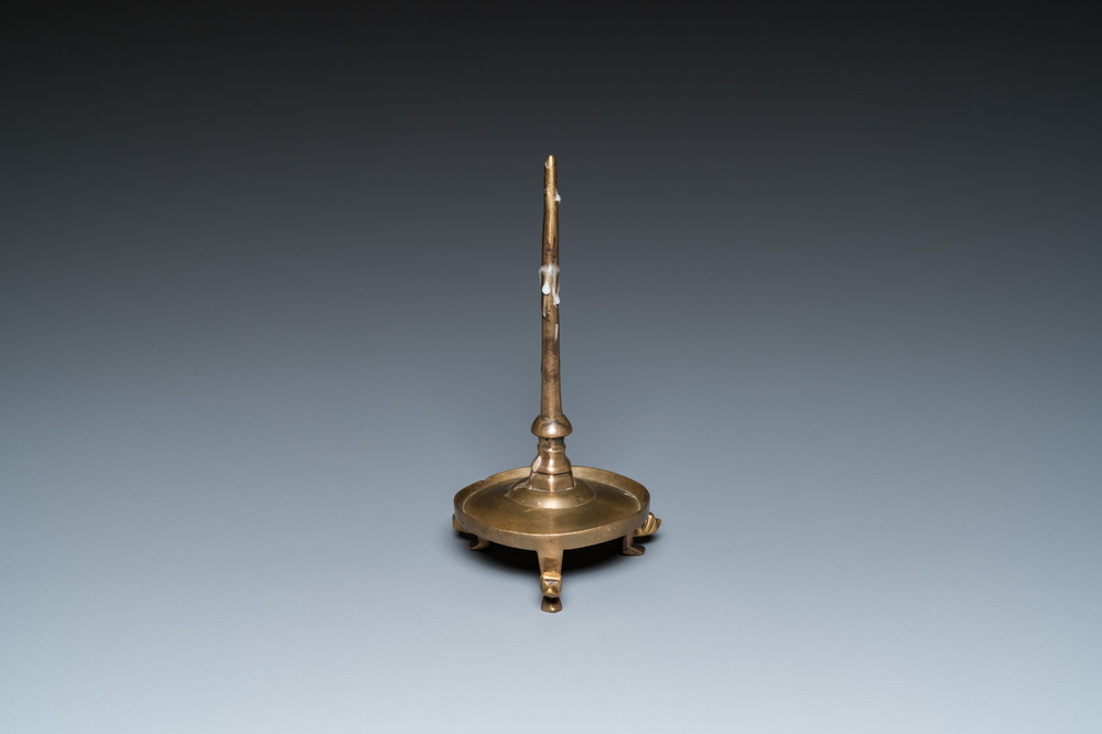 A Flemish or Dutch bronze candlestick, 14/15th C.