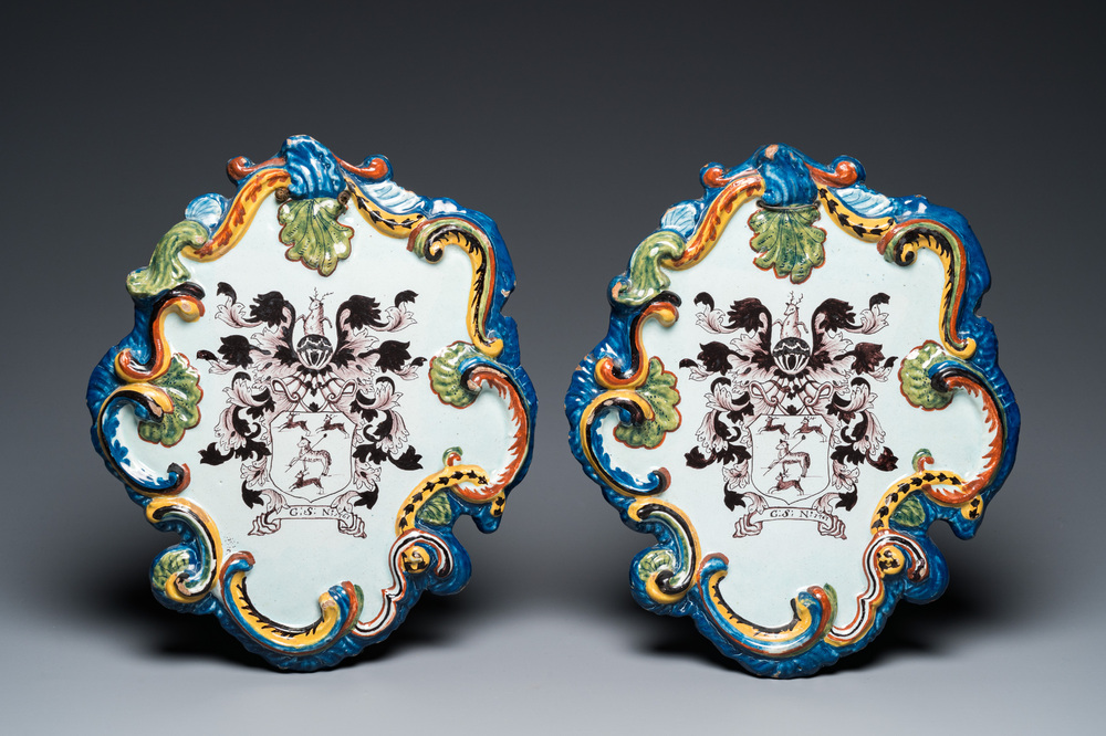 A pair of polychrome Dutch Delft armorial plaques dated 1767