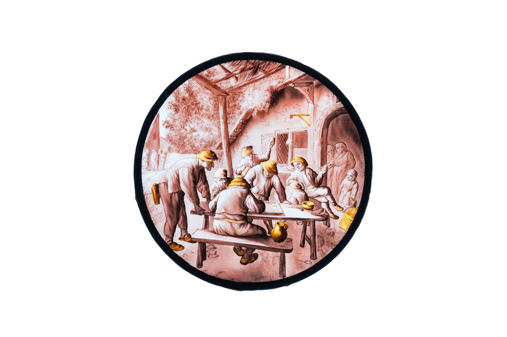 A painted glass roundel with 'The Backgammon-players' after Adriaen van Ostade, Southern Netherlands, 17/18th C.
