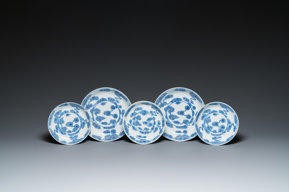 Two Chinese blue and white 'clouds' dishes and three plates, 19th C.