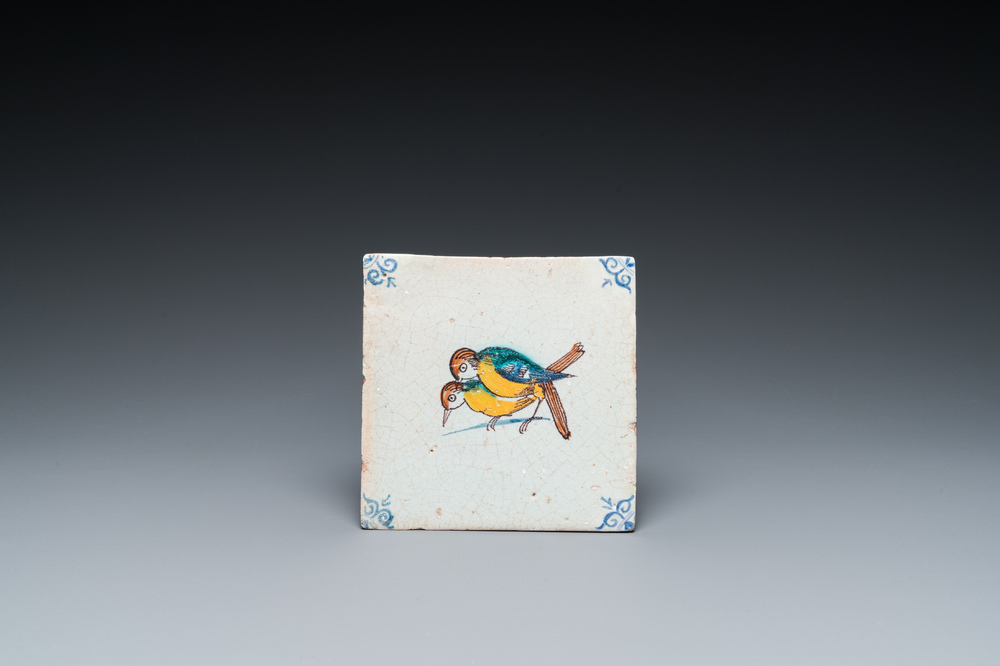 A rare polychrome Dutch Delft tile with mating birds, 17th C.