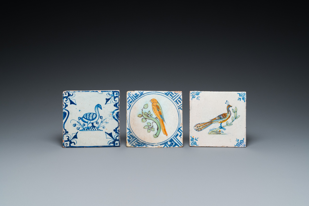 Two polychrome Dutch Delft tiles with a parrot and a peacock, and a blue and white one with a goose, 17th C.
