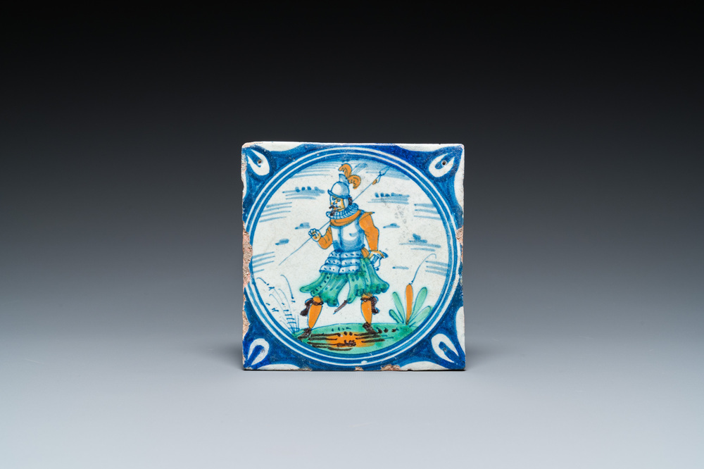 A polychrome Dutch maiolica medallion tile with a soldier, late 16th C.