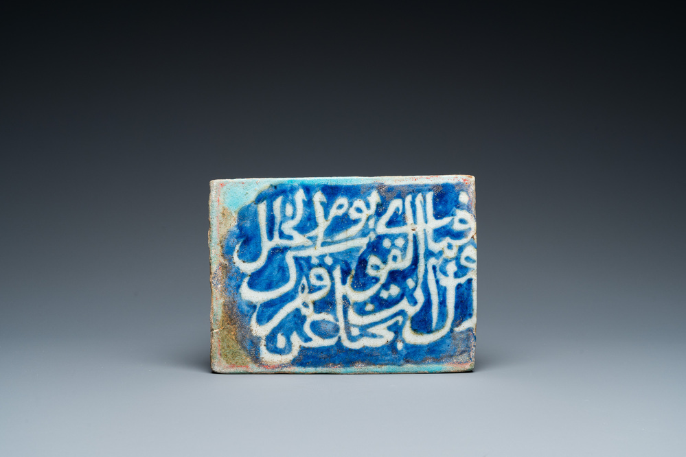 Een islamitische kalligrafische tegel in blauw, turquoise en wit, 17e eeuw