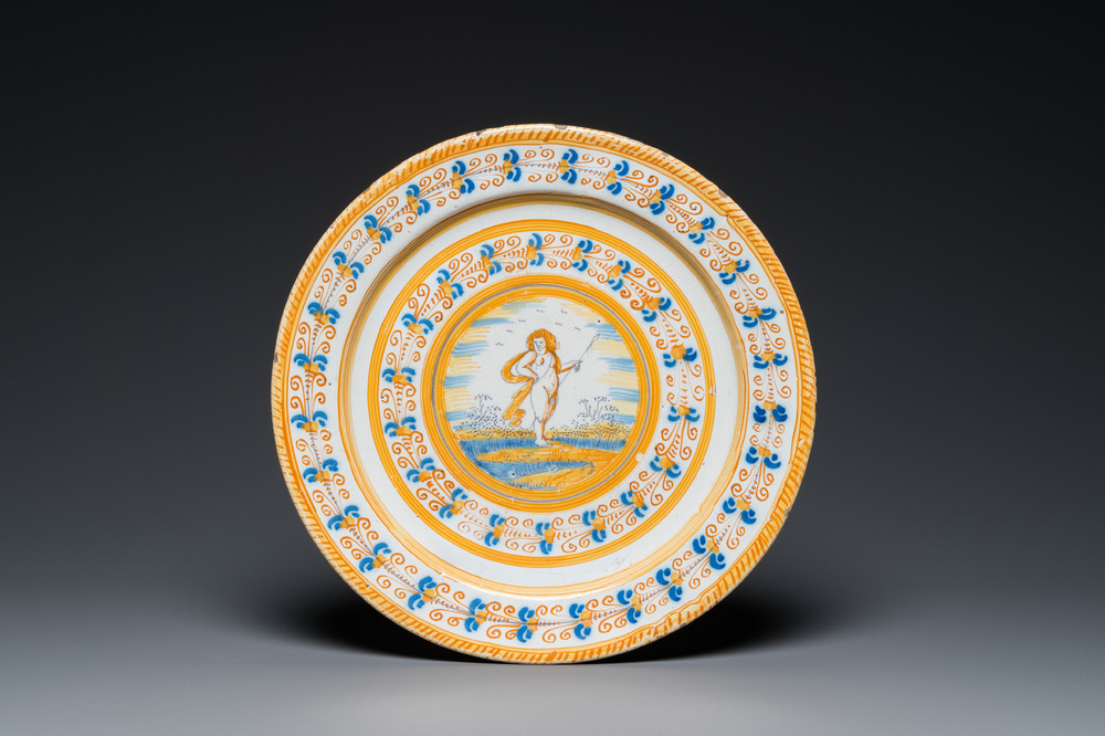 A blue, white and yellow Dutch Delft 'putto' dish, Verstraeten workshop, Haarlem, ca. 1640-1660