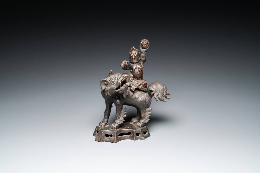 A Chinese bronze censer and cover in the shape of a Luohan on a Buddhist lion, late Ming/early Qing