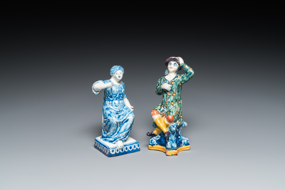 A polychrome Dutch Delft figure of a seated man and a blue and white one of a seated lady, 18th C.