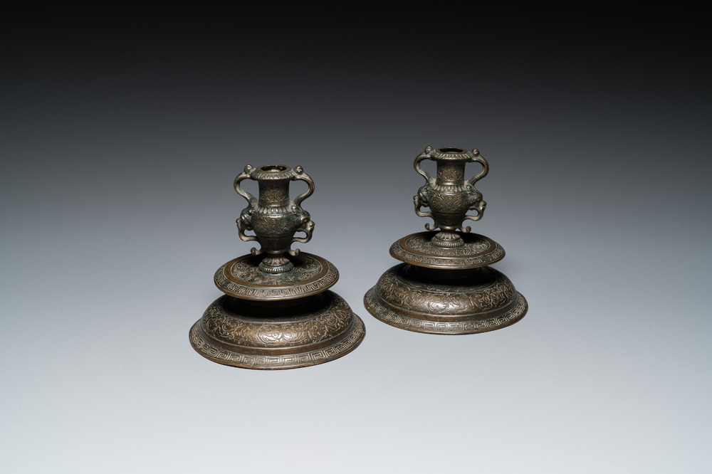 A pair of Italian engraved bronze candlesticks, probably Venice, 16th C.