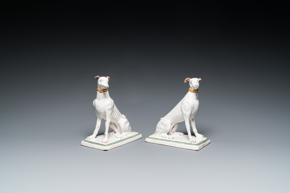 A pair of polychrome Brussels faience greyhounds, 18th C.