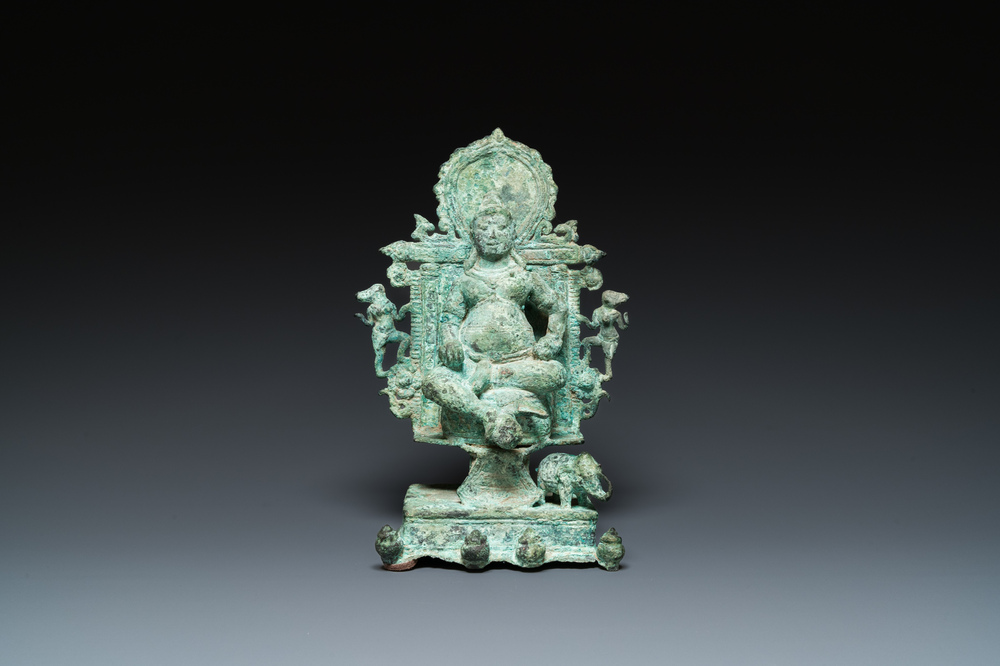 A bronze group with Kubera on a throne, Central Java, Indonesia, 11/12th C.