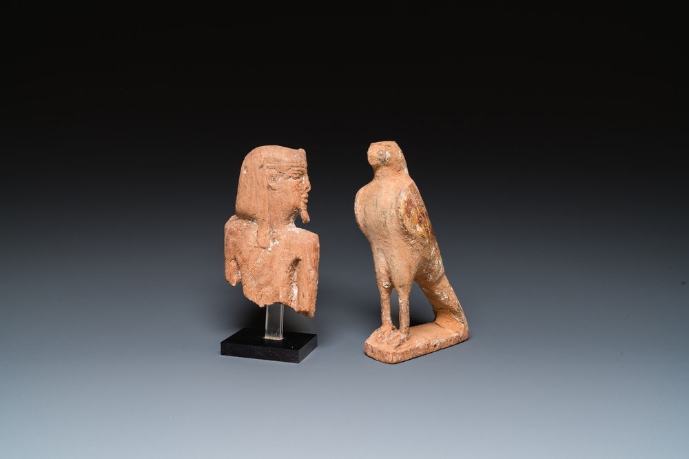 An Egyptian wooden Horus falcon and a fragment of a farao sculpture, Late Period