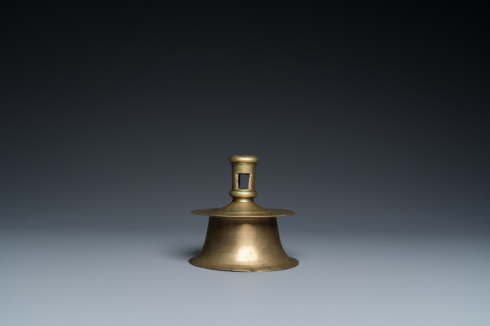 A Flemish brass capstan candlestick, 16th C.
