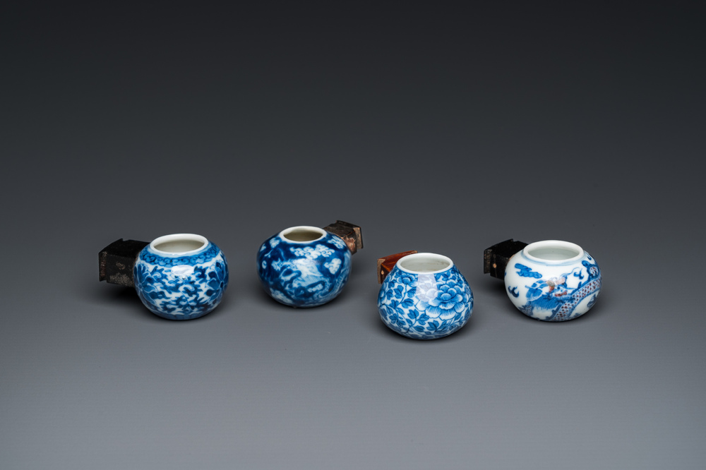 Four Chinese blue, white and copper-red bird feeders, 19th C.