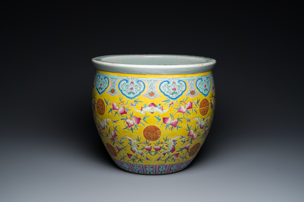 A Chinese famille rose yellow-ground fish bowl with bats and peaches, 19th C.