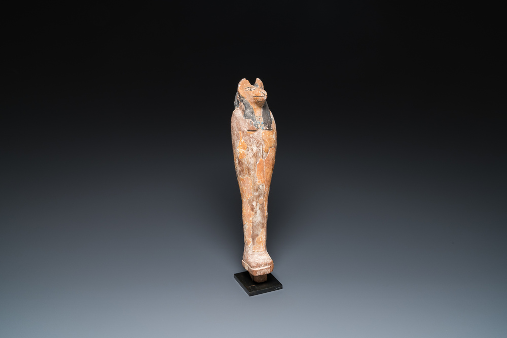 An Egyptian stucco painted wooden mummiform figure of Anubis, New Kingdom