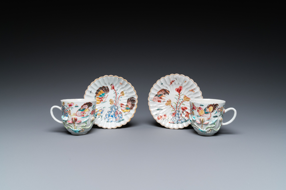 A pair of Chinese famille rose relief-decorated cups and saucers, Yongzheng