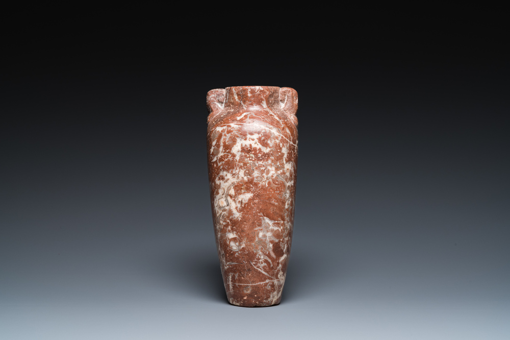 An Egyptian red Breccia jar, Predynastic period, 3500-2900 b.C.