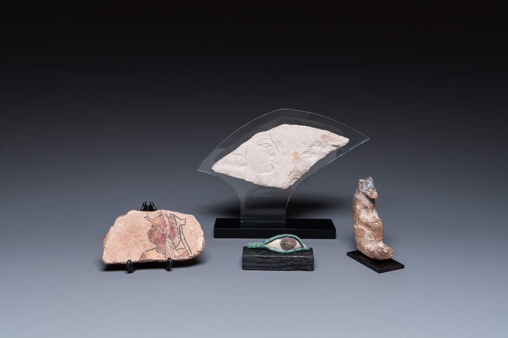 A limestone sculpture of Anubis, two sarcophagus fragments and a fragment of a carved relief, Late period