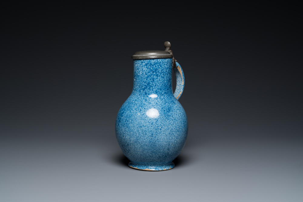 A monochrome blue Brussels faience jug with pewter cover, 18th C.