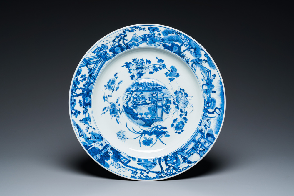 A large Chinese blue and white dish with raised central medallion, Kangxi